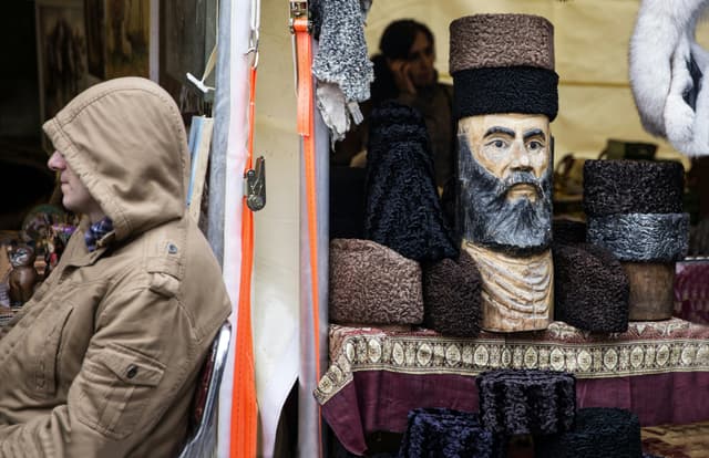 Explore a traditional market in Baku, Azerbaijan, featuring unique astrakhan hats and cultural crafts.