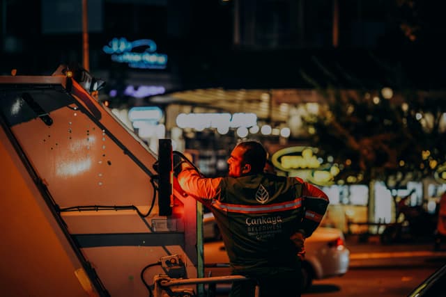 Sanitation worker in Ankara doing urban night work, enhancing city cleanliness.