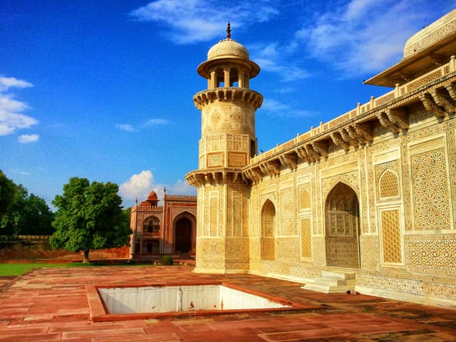 Stunning Indian monument showcasing intricate designs under a bright blue sky, perfect for travel enthusiasts.