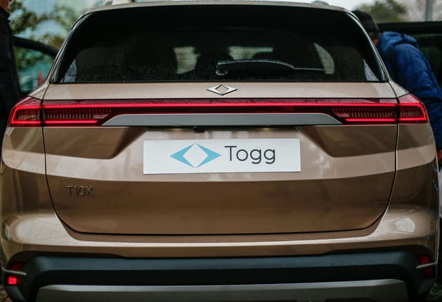 Rear view of a brown TOGG T10X electric SUV in Malatya, Türkiye, showcasing modern design.