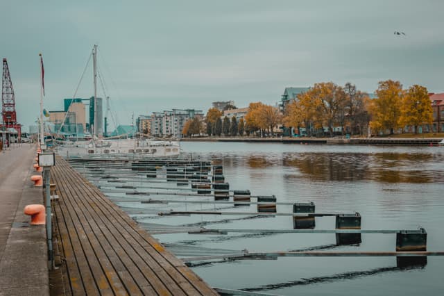 Serene autumn view of a marina with moored boats in Halmstad, Sweden.