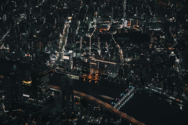 A captivating aerial view of Tokyo's luminous cityscape at night, showcasing urban life and architecture.