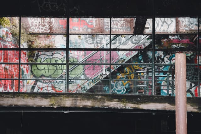 Vibrant graffiti covers the facade of an abandoned industrial building in Abbotsford, VIC, Australia.