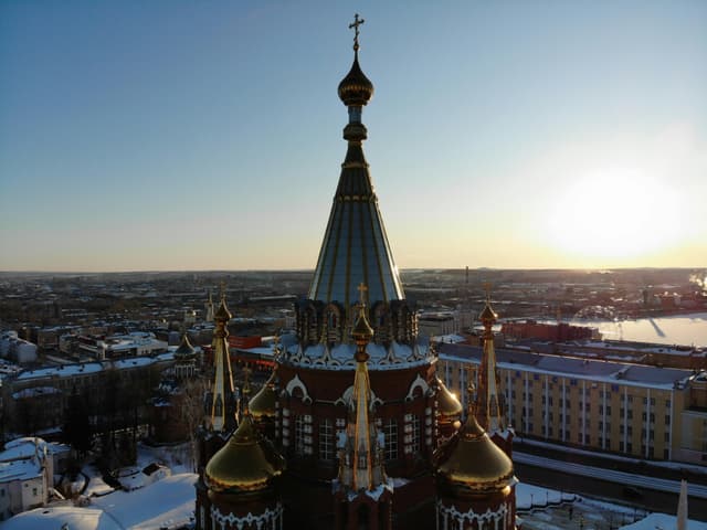 A breathtaking aerial view of Saint Michael Cathedral in Izhevsk, Russia during winter at sunset.