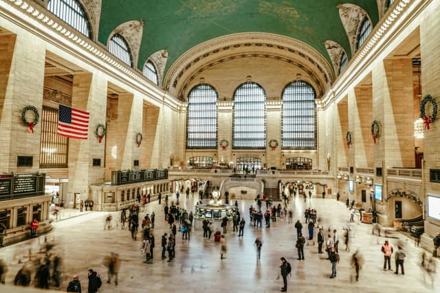 Bustling interior view of Grand Central Terminal with commuters and iconic architecture.
